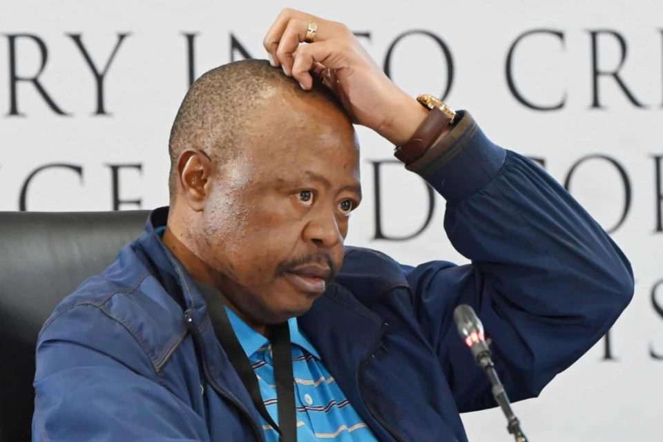 Man on blue scratches his head.